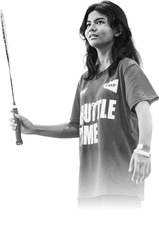 A woman wearing a red shirt and black shorts holds a tennis racket. AI generated content