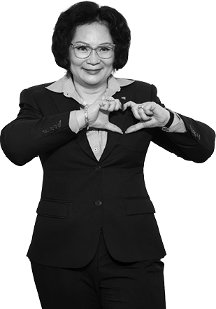 A woman wearing a suit and tie is making a heart shape with her hands. AI generated content