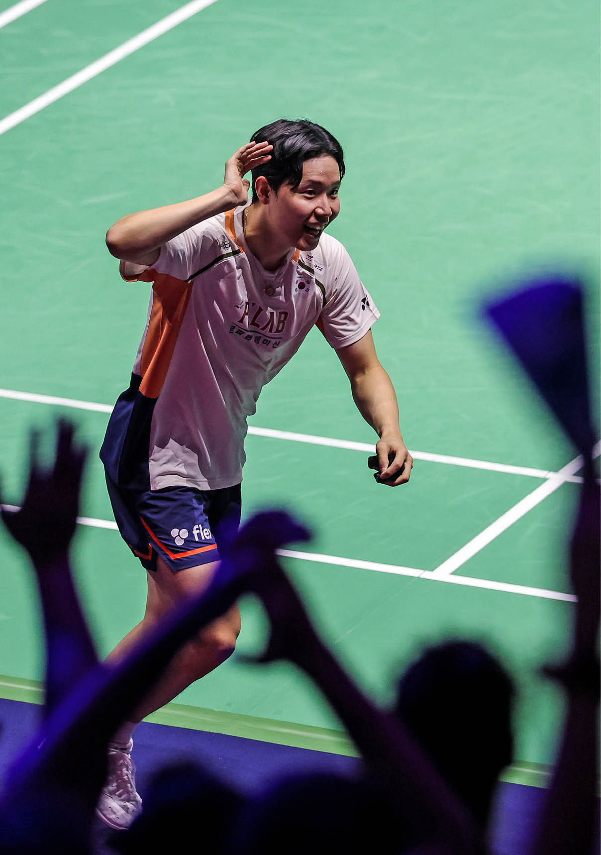 A tennis player celebrates a victory with a crowd of fans. AI generated content