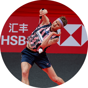 A man wearing a pink and blue shirt is playing tennis. AI generated content