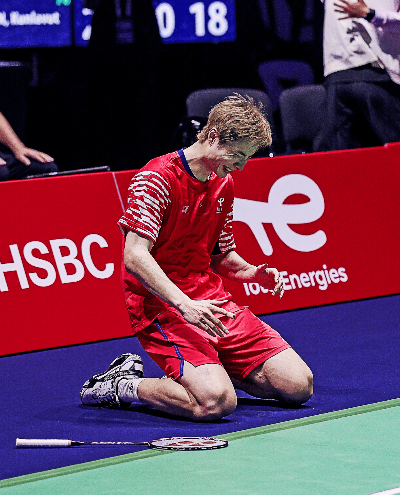 A tennis player is kneeling on the court, holding his racket. AI generated content