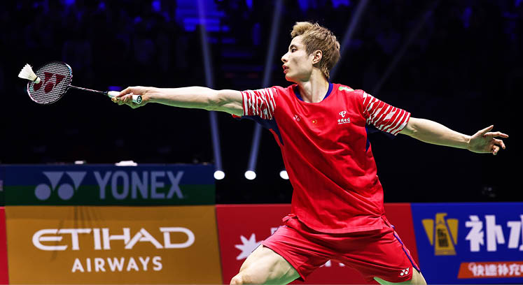 A man in a red shirt is playing tennis, swinging his racket at a ball. AI generated content