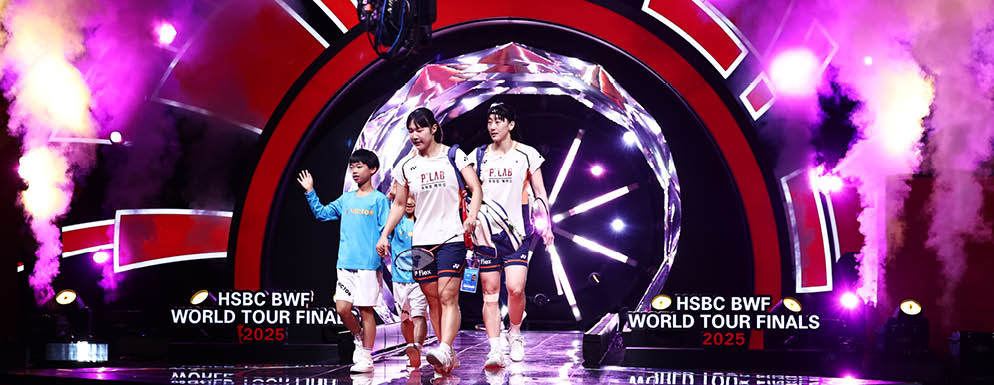 Three men are standing on a stage in front of a large clock. They are wearing shorts and white shirts. AI generated content