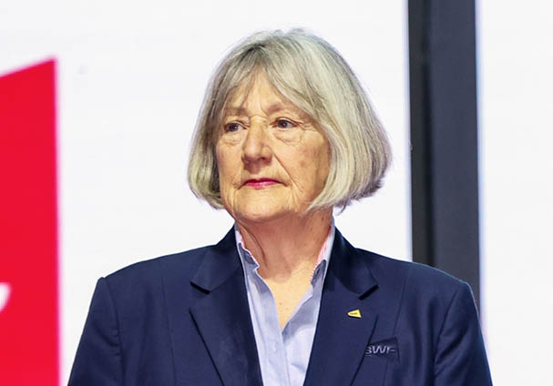 Two women are holding awards on stage. AI generated content