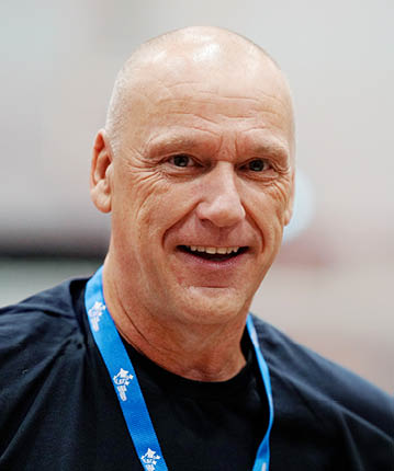 A bald man wearing a black shirt and a blue lanyard around his neck. AI generated content