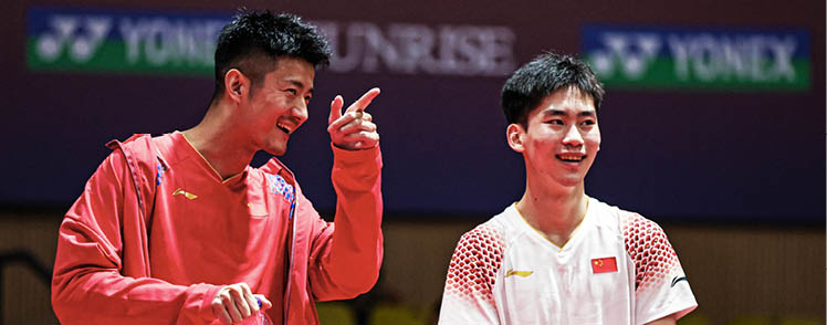 Two men are standing on a tennis court, both holding their hands up. One of them is wearing a red shirt and holding a bottle. AI generated content