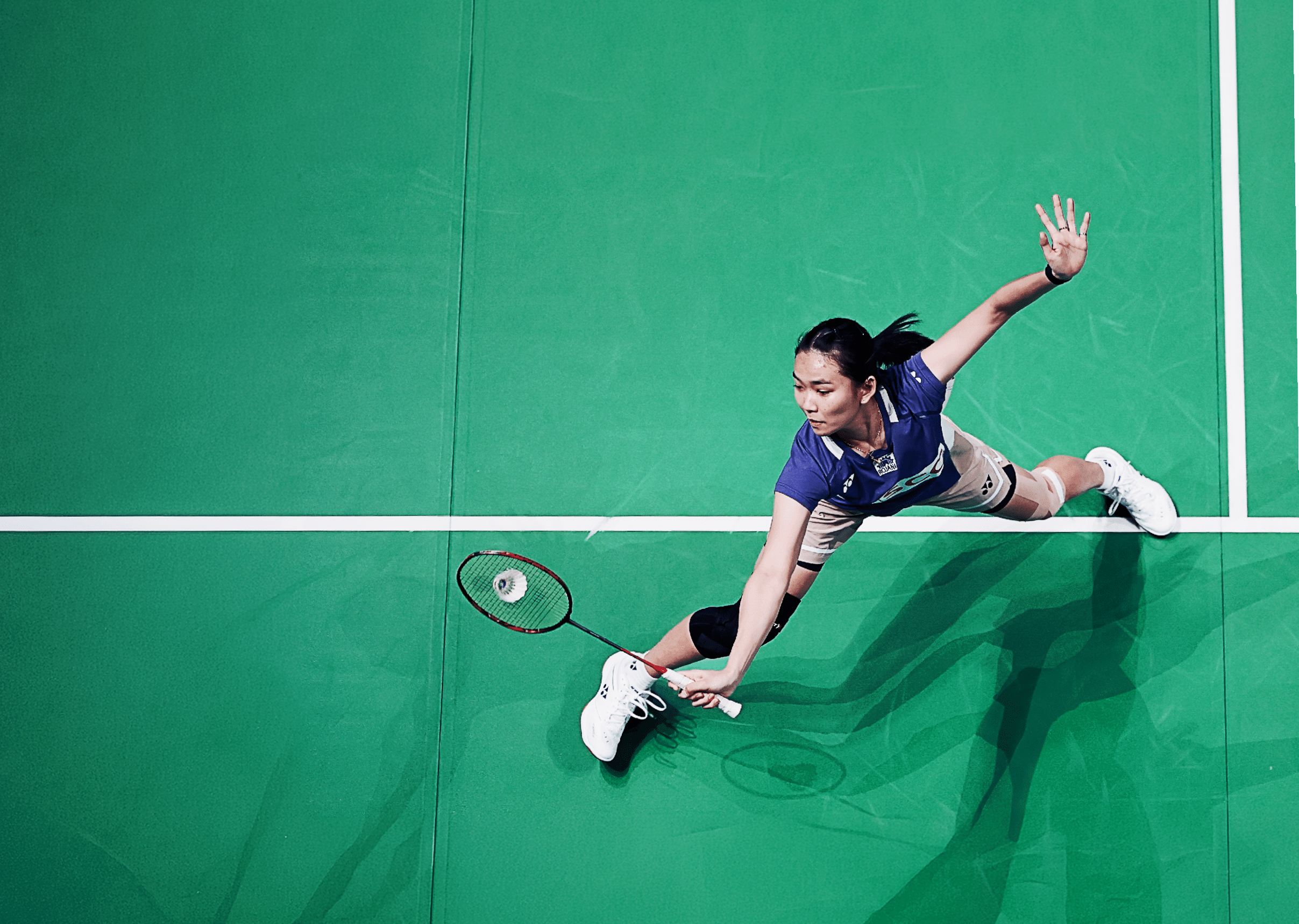 A woman is playing tennis on a court, swinging her racket to hit the ball. AI generated content