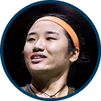 A woman wearing a black shirt with the word “PLA" on it is holding her arms up in the air. AI generated content