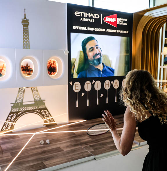 A woman is playing a video game in a room with a large screen. AI generated content