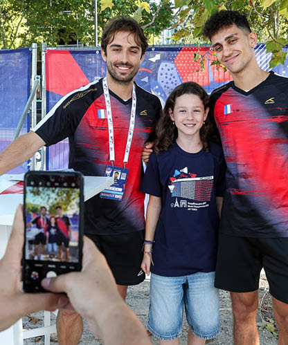 Two men and a girl pose for a picture in front of a fence. AI generated content