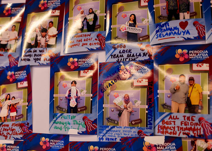 A collection of photos of people are displayed on a table. AI generated content