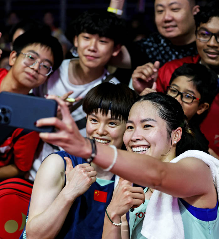 A group of people are gathered around a woman taking a selfie. AI generated content