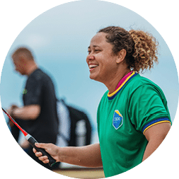 A woman is holding a tennis racket, smiling and posing for a picture. AI generated content