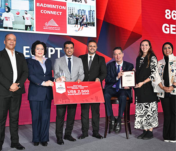 A group of people are standing in front of a stage, some of them holding red envelopes. AI generated content