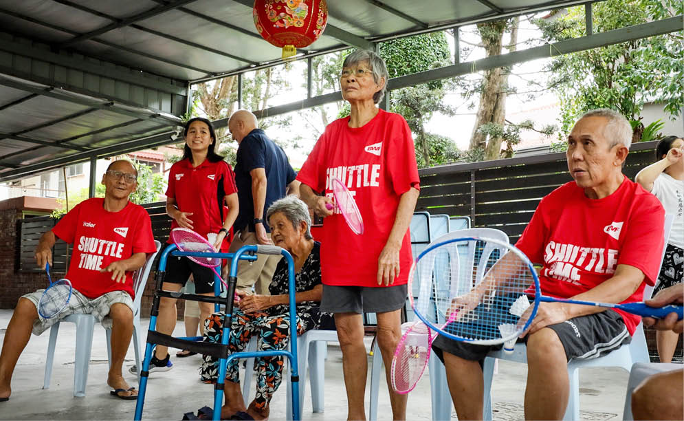 A group of people are sitting on chairs, holding tennis rackets. AI generated content