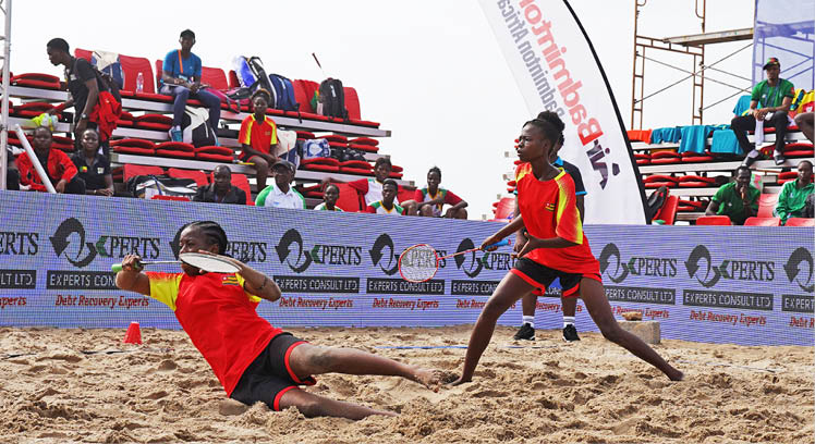 Two people playing frisbee on a sandy beach. AI generated content