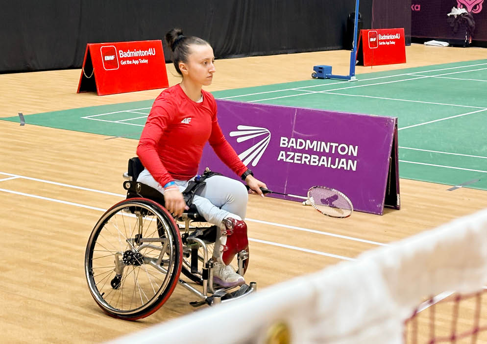 A woman in a wheelchair is playing tennis on a court. AI generated content