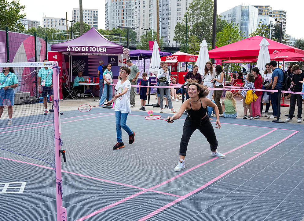 Two women playing tennis in a public area. AI generated content