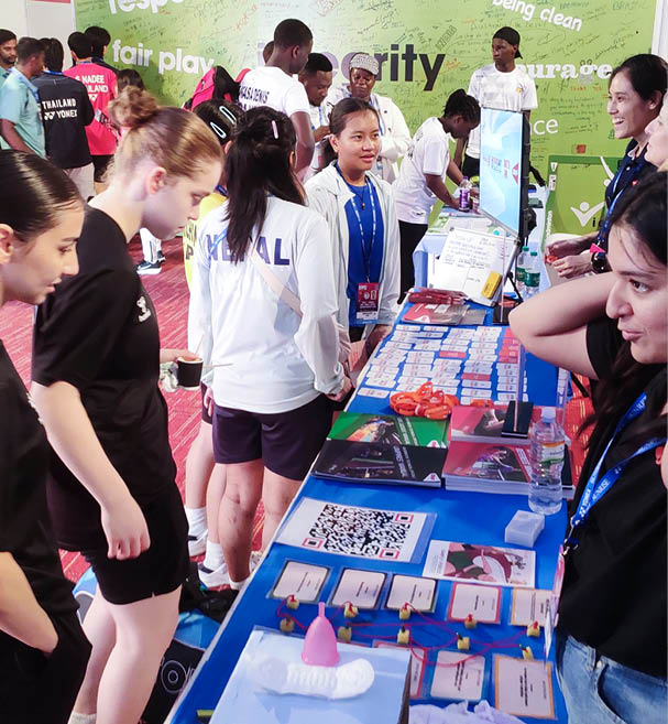 A group of people are gathered around a table with a blue cloth, looking at items on the table. AI generated content