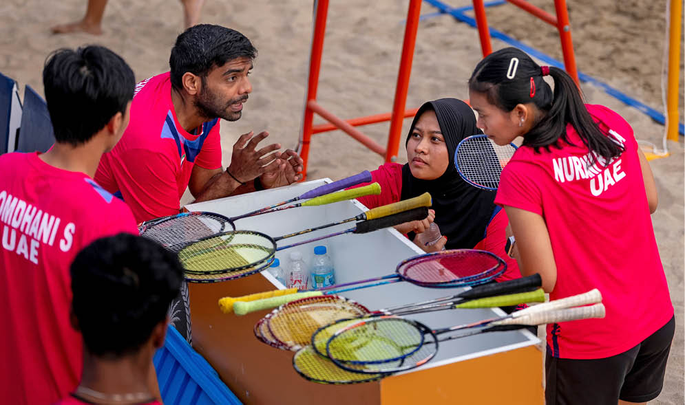 A group of people are gathered around a table with multiple tennis rackets on it. AI generated content