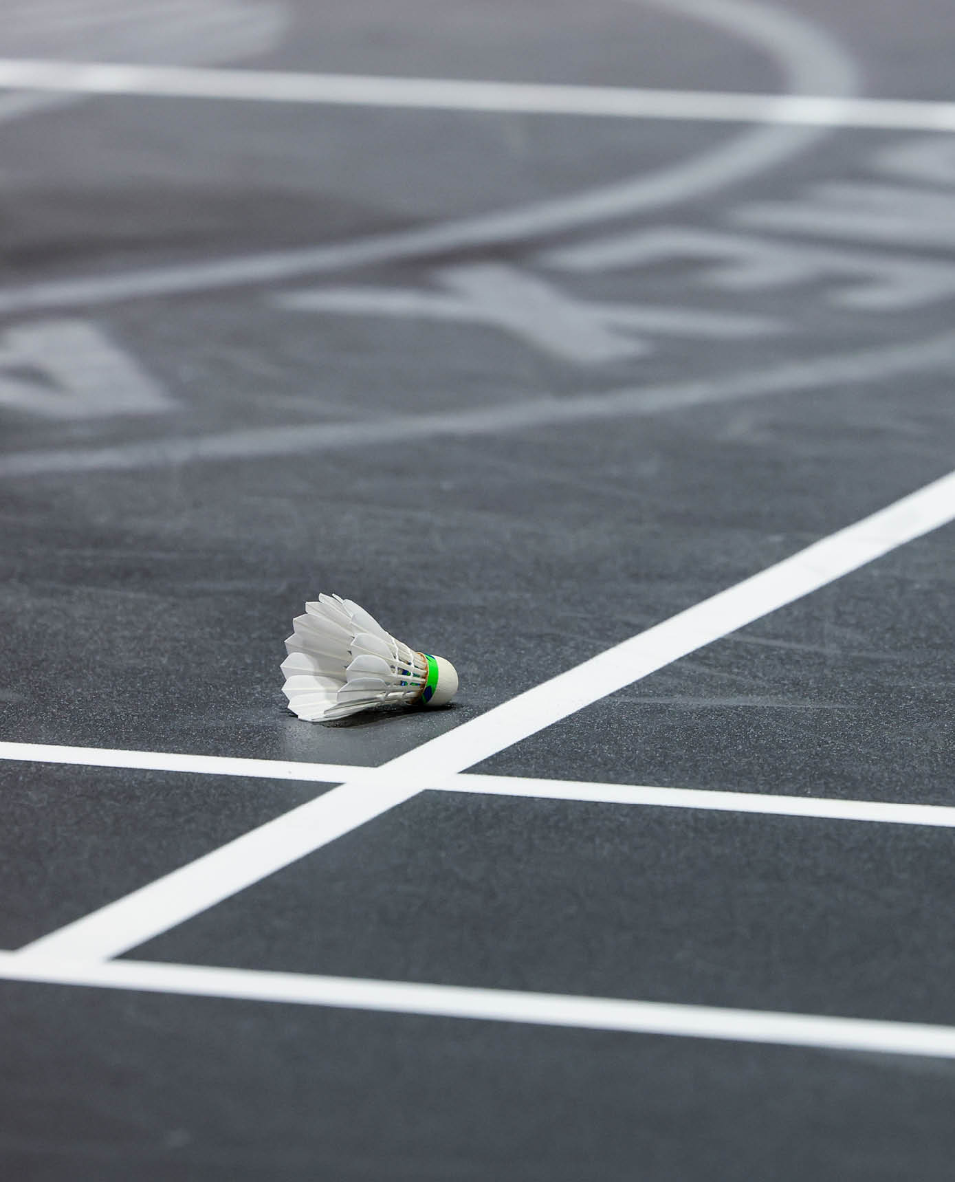 A tennis racket is lying on the ground on a tennis court. AI generated content