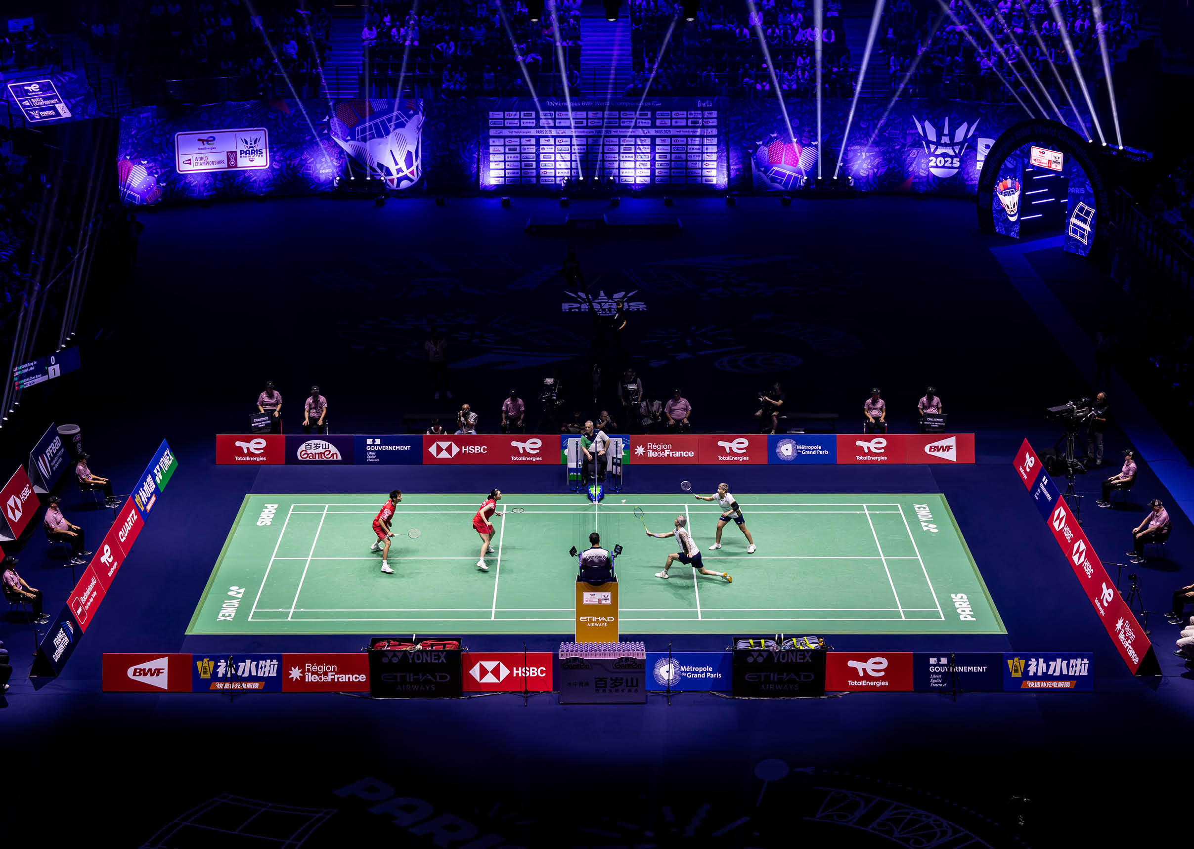 A group of men playing a game of badminton in a darkened arena. AI generated content